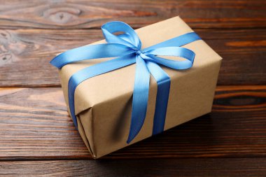 Ahşap arka planda güzel bir hediye kutusu, yakın plan.