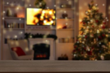 Boş ahşap masa, bulanık odaya karşı, Noel ağacı ve ışık var. Tasarım için boşluk