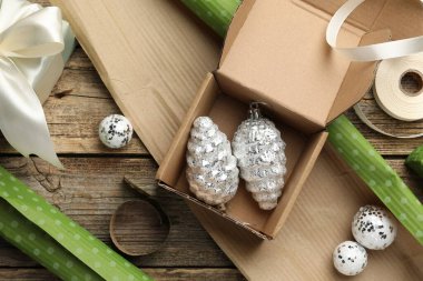 Kutlama ambalajı. Hediye kutuları, ambalaj kağıtları, takılar ve tahta masa üzerindeki kurdele, düz yatış. Mutlu Noeller ve mutlu yıllar.