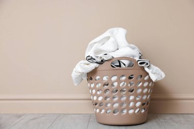 Bej duvarın yanında çamaşır sepeti, metin için boşluk.