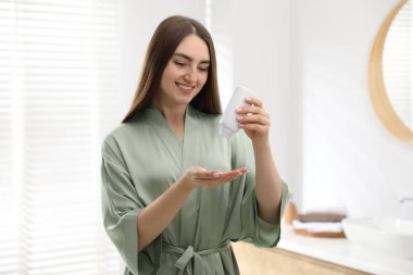 Evde pudra gibi pudra kullanan bir kadın.