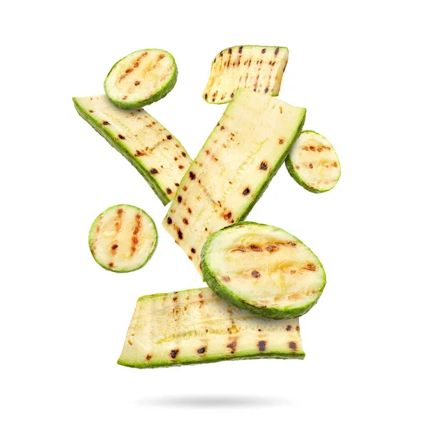 Izgara kabak parçaları beyaz arka plana düşüyor.