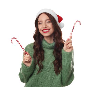 Beyaz arka planda Noel Baba şapkası ve baston şekerleri olan güzel bir kadın. Noel sezonu