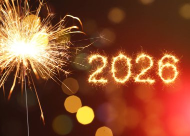 Kırmızı arka planda maytap ve bokeh ışıkları olan mutlu yıllar 2026 tebrik kartı.