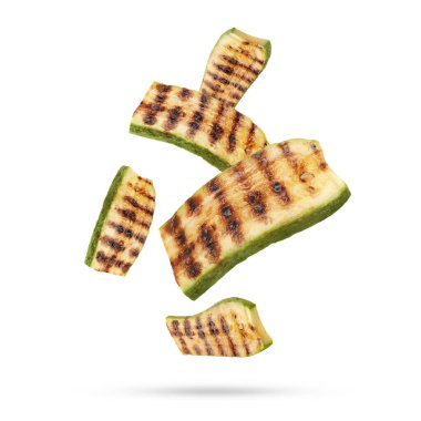 Izgara kabak parçaları beyaz arka plana düşüyor.