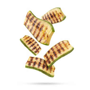 Izgara kabak parçaları beyaz arka plana düşüyor.