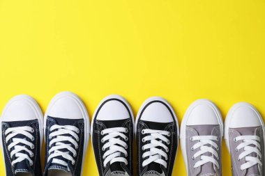 Sarı arka planda şık bir çocuğun spor ayakkabısı, düz bir şekilde yatıyordu. Metin için boşluk