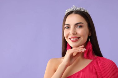 Menekşe arka planda lüks taç giyen güzel bir kadın.