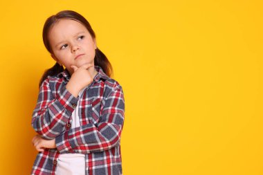 Turuncu arka planda şirin küçük bir kızın portresi, mesaj için boşluk