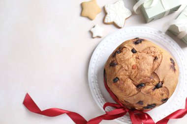 Lezzetli Noel panettonlu pasta, zencefilli kurabiye ve bej masadaki hediyeler, düz yatak. Metin için boşluk