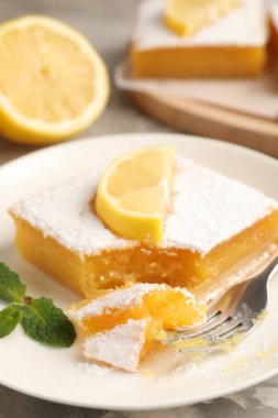 Tasty lemon bar with mint and fresh fruit on table, closeup