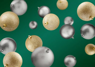 Christmas balls falling on dark green background. Golden and silver festive ornaments