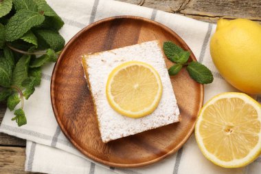 Tasty lemon bar with mint and fresh fruits on wooden table, flat lay