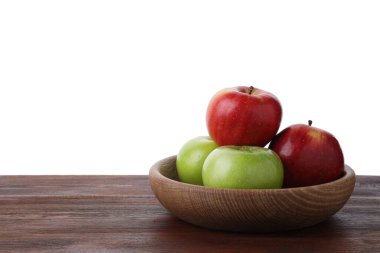 Kırmızı ve yeşil olgun elmalar kasede tahta masada beyaz arka planda