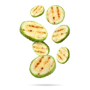 Izgara kabak parçaları beyaz arka plana düşüyor.