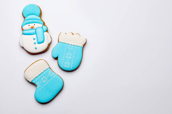 Tasty gingerbread cookies on white background, flat lay with space for text. Christmas treat