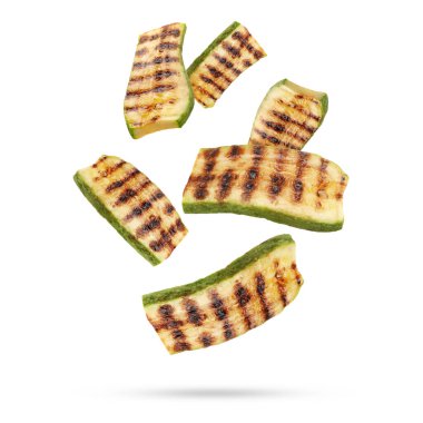 Izgara kabak parçaları beyaz arka plana düşüyor.