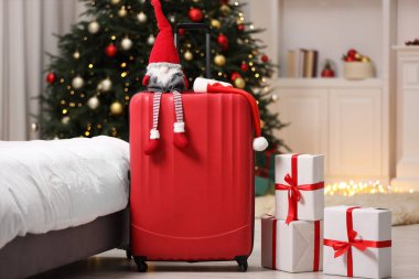 Noel tatili. İçinde Noel Baba şapkası, cüce ve hediye kutuları olan çanta.