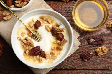 Tahta masada servis edilen bal ve fındıklı lezzetli Yunan yoğurdu.