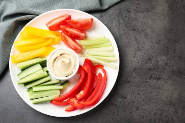 Gri masada farklı taze sebzeler ve sos, üst manzara. Metin için boşluk