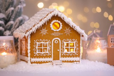 Güzel zencefilli kurabiye evi ve Noel dekoru bulanık ışıklara karşı, yakın plan