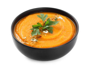 Lezzetli balkabağı kremalı çorba, maydanozlu ve beyaz tencereli.