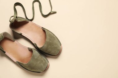 Bej arka planda bir çift şık ayakkabı, üst manzara. Metin için boşluk