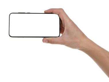 Man holding smartphone with blank screen on white background, closeup. Mockup for design