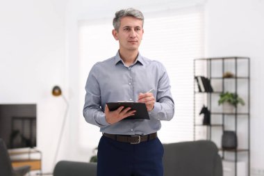 Gayrimenkul değerlendirmesi. Evdeki mülkiyet değerini bildiren pano ile müfettiş.