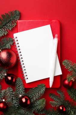 New Year aims. Planners, pen and festive decor on red background, flat lay
