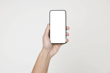 Man holding smartphone with blank screen on white background, closeup. Mockup for design