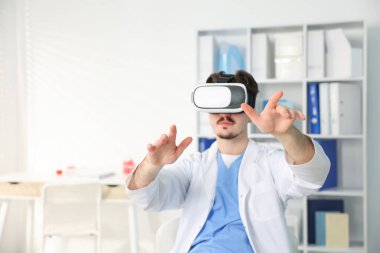 Modern teknoloji. Ofiste sanal ekranı kullanan kulaklıklı bir doktor. Metin için boşluk