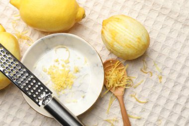 Lezzetli, kaşıklı ve rendelenmiş taze limonlar masa örtüsünde, düz bir şekilde yatıyordu.