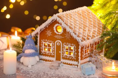 Güzel zencefilli kurabiye evi ve Noel dekoru bulanık ışıklara karşı, yakın plan