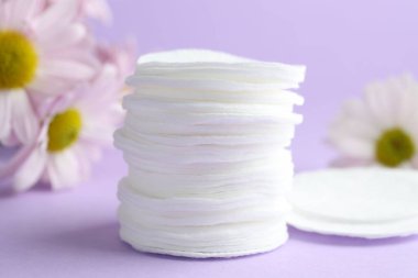 Leylak arka planında temiz pamuk pedleri ve çiçekler, yakın plan.