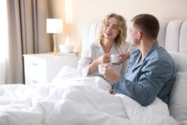 Hoş bir çift evde sıcak içeceklerin tadını çıkarıyor.