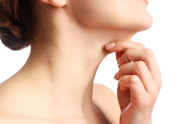 Beyaz arka planda boynuna dokunan kadın, yakın plan.