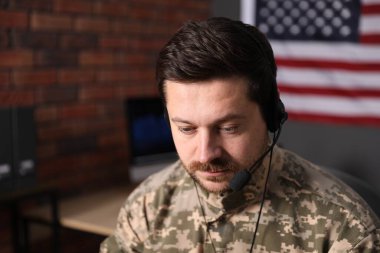 Askerlik. Ofiste çalışan kulaklıklı asker, metin için alan