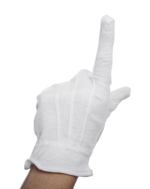 Kumaş eldivenli kadın beyaz arka plandaki bir şeyi işaret ediyor, yakın plan.