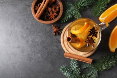 Lezzetli, portakallı, baharatlı ve köknar dallı beyaz şarap. Koyu dokulu masa, düz yatak. Metin için boşluk