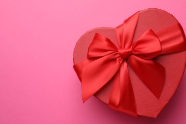 Pembe arka planda güzel kalp şekilli hediye, üst manzaralı metin için alan. Sevgililer Günü