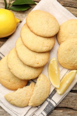 Lezzetli limonlu kurabiyeler ve ahşap masada meyve dilimleri.
