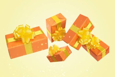 Hediye kutuları sarı arka planda bokeh ışıklarıyla havada uçuşuyor.