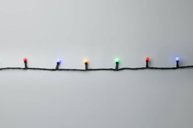 Gri arka planda parlak Noel ışıkları, üst manzara