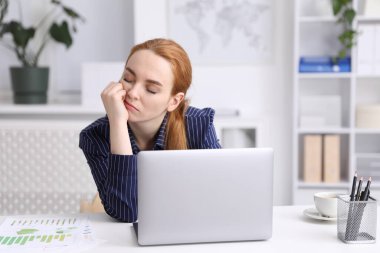 Ofiste uyuyan yorgun bir kadın.