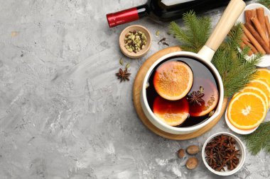 Lezzetli haşlanmış şarap ve gri desenli masa üzerindeki malzemeler, düz yatak. Metin için boşluk