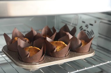 Lezzetli kekler fırında pişiyor, yakından görülüyor.