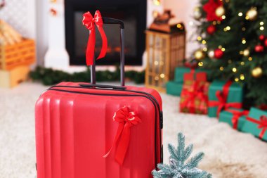Fiyonklu bavul ve kapalı alanda şenlikli dekor, yakın plan. Noel tatili