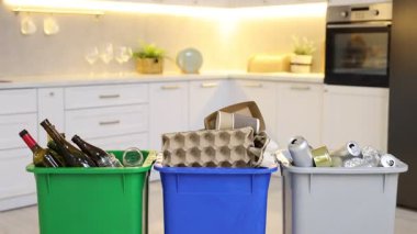 Mutfaktaki çöp kutularında çöp, kamera ilerliyor. Atık sıralama