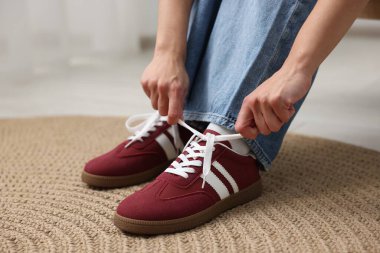 Kadın şık ayakkabılar giyiyor, kapalı mekanda, yakın plan.